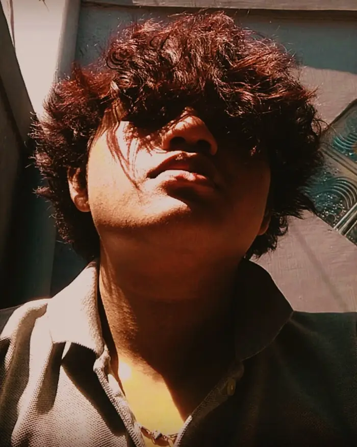 Moody portrait of Jaya Anggara with curly hair