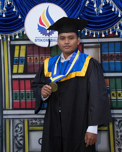 Jaya Anggara in a graduation gown at STIKOM Bali